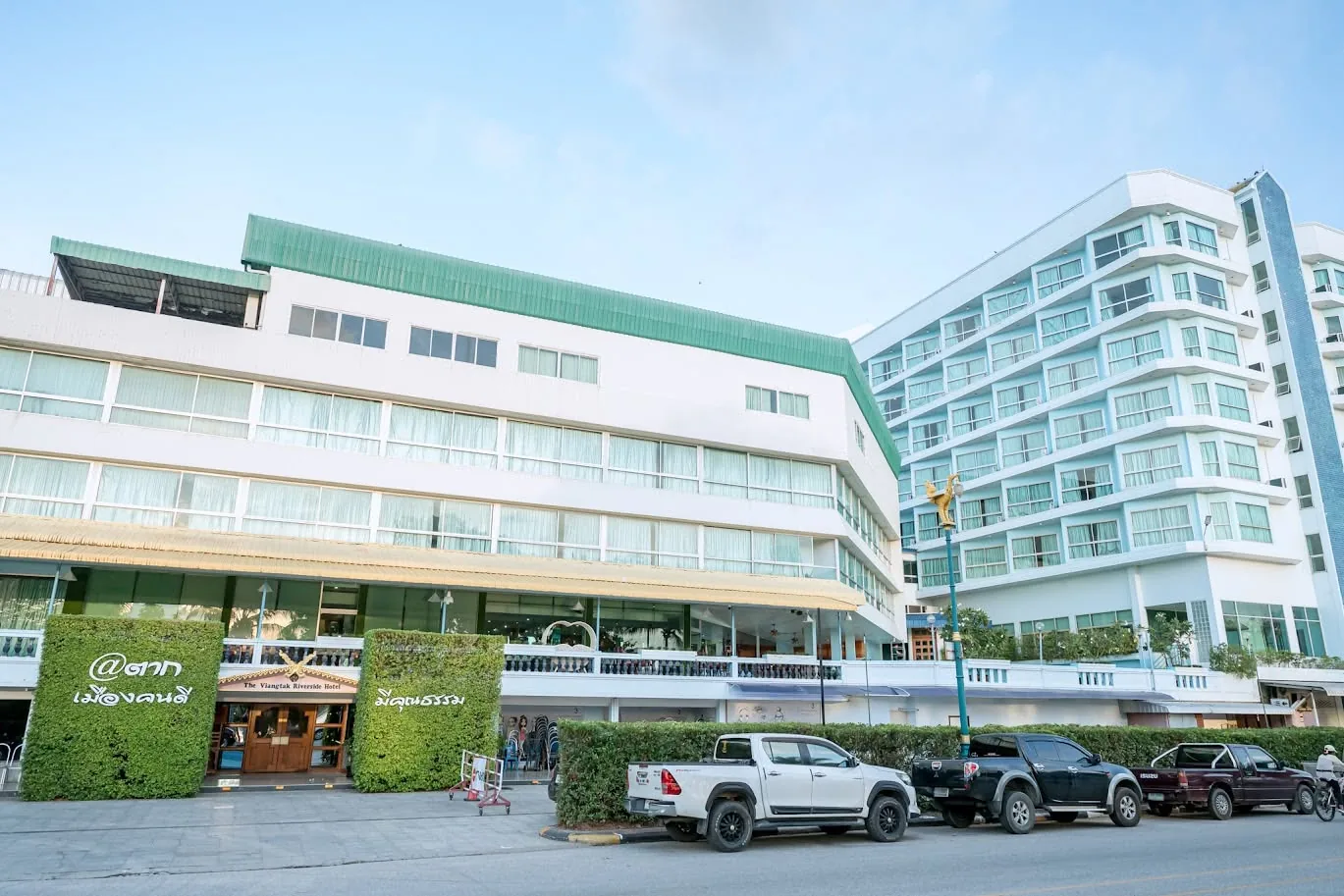 The hotel entrance on Chomphon Road, with cars parked outside