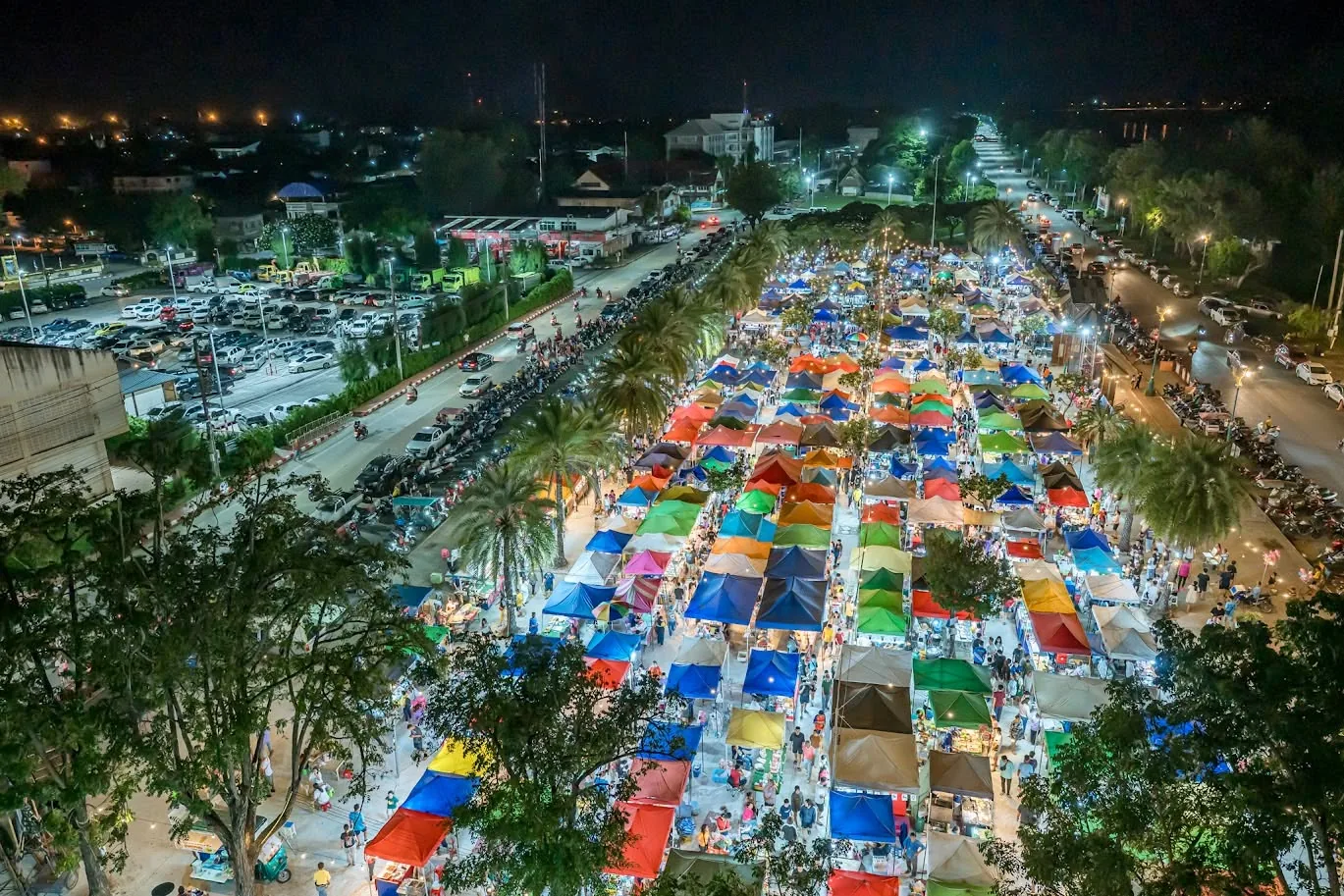 An aerial view of the riverside night market, lit up after dark